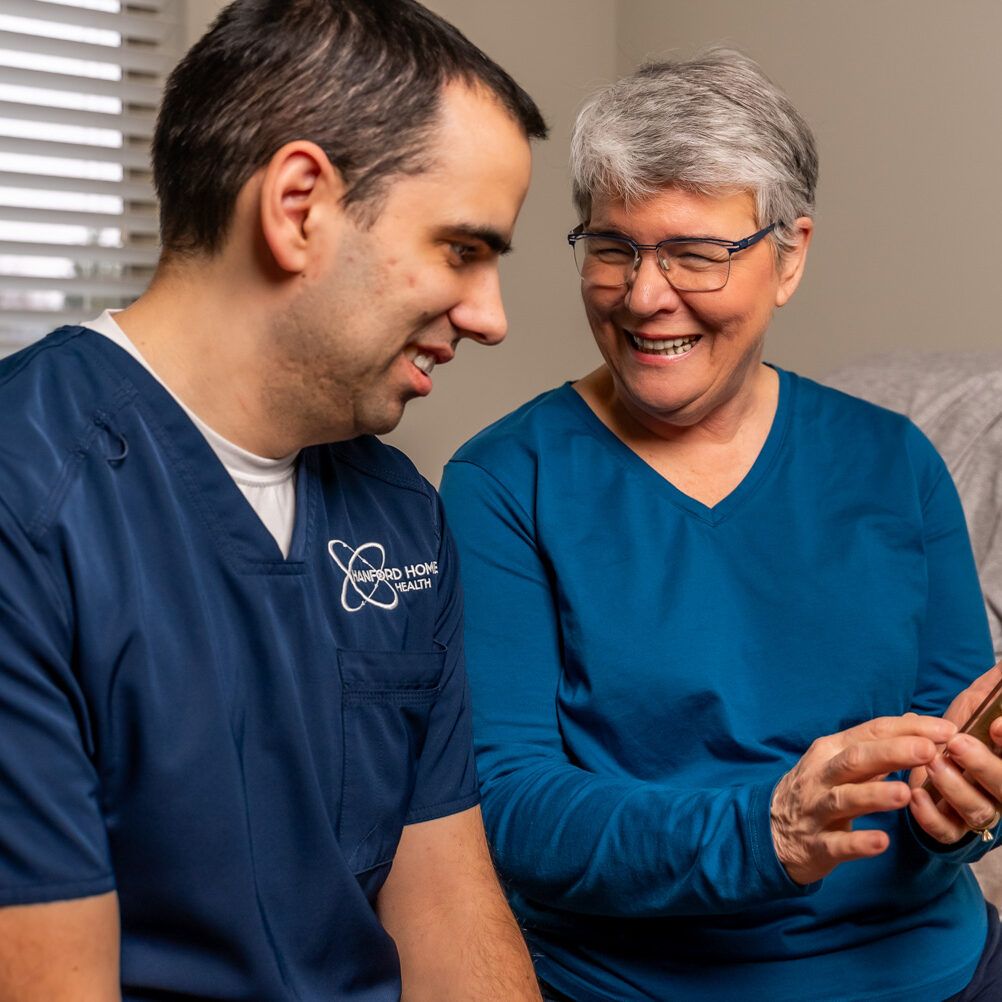 Hanford Home Health_Website Shoot_02.2025-00027 patient showing Hanford Home Health nurse something on her phone