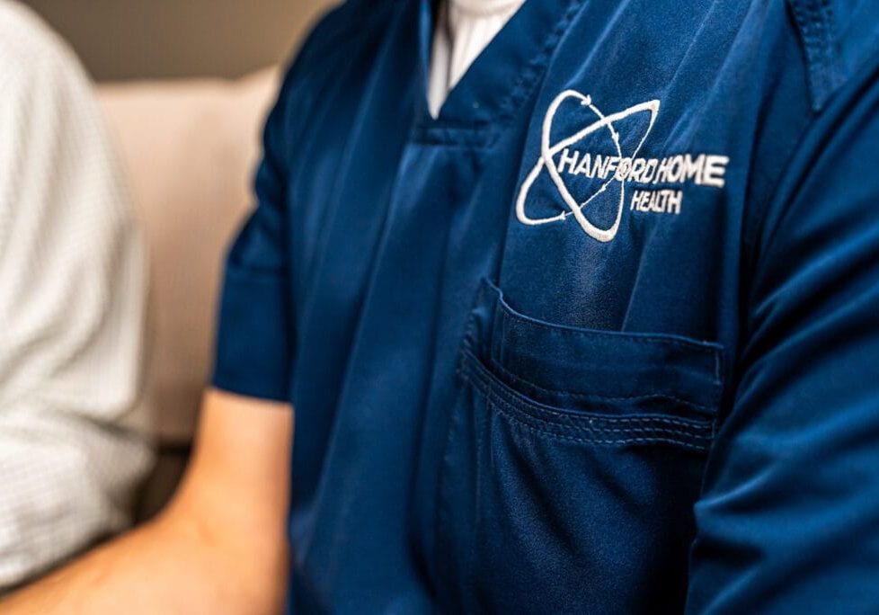 close up of Hanford Home Health logo on scrubs