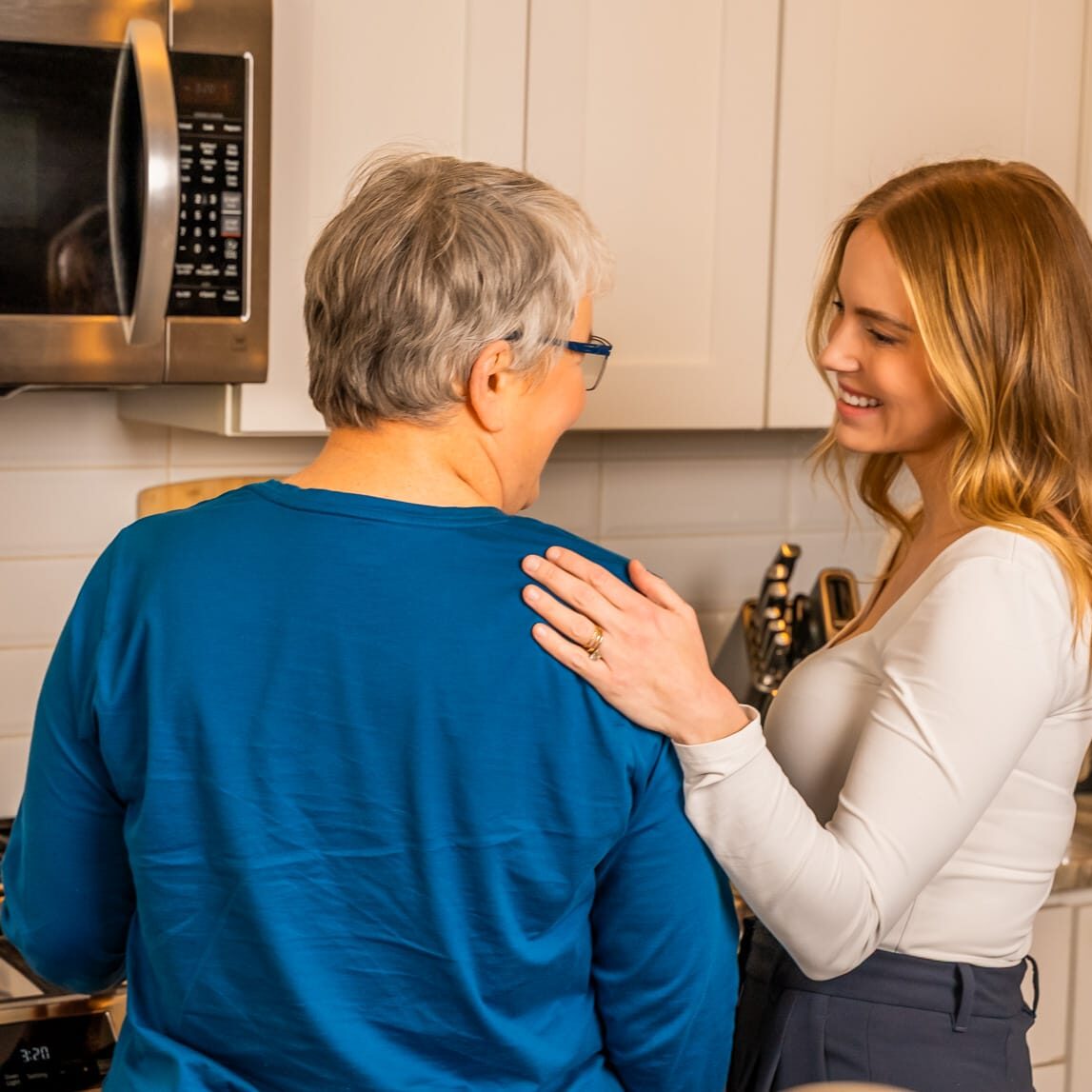 nurse helping a patient in the kitchen